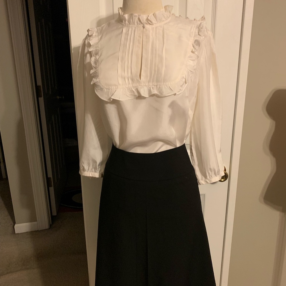 This off white Ruffle Blouse can be worn with skirt or pants.